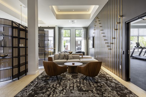 A modern living room with a black and gold accent wall.