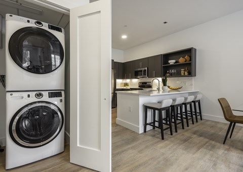 A white washing machine and dryer in a laundry room.