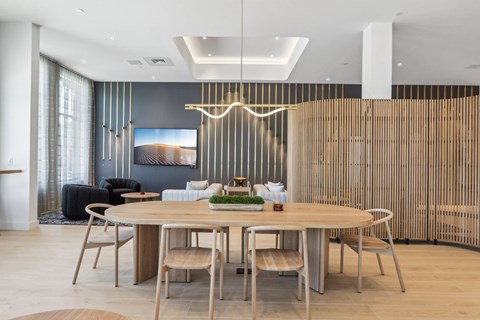 A modern dining room with a round table and chairs.