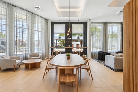 A modern living room with a wooden table and chairs.
