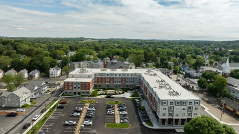 A large building with a parking lot in front of it.