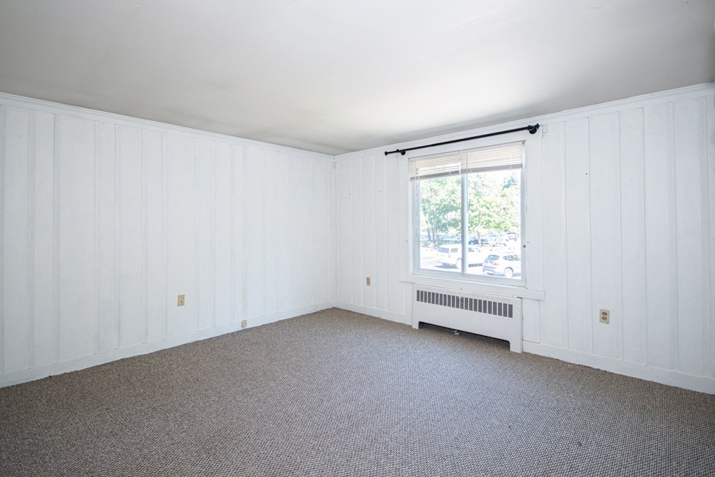 a bedroom with a radiator and a window
