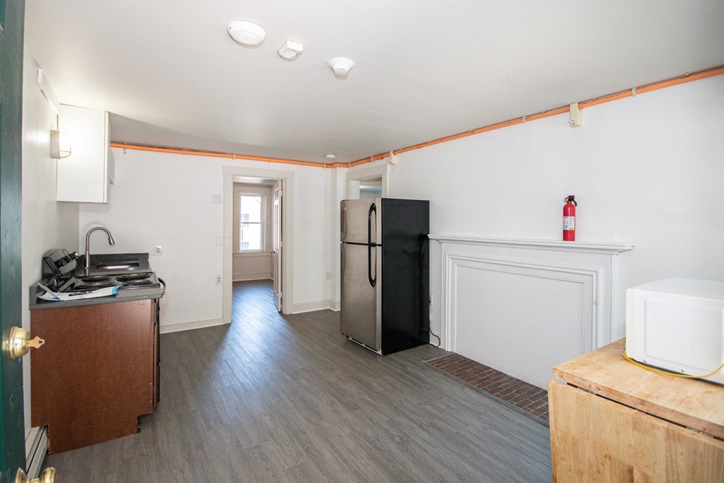 a kitchen with a refrigerator and a stove