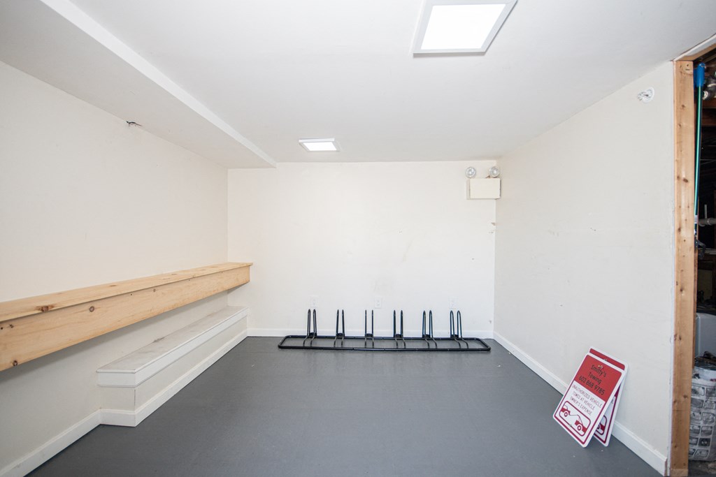 a room with a bench and a sign on the floor