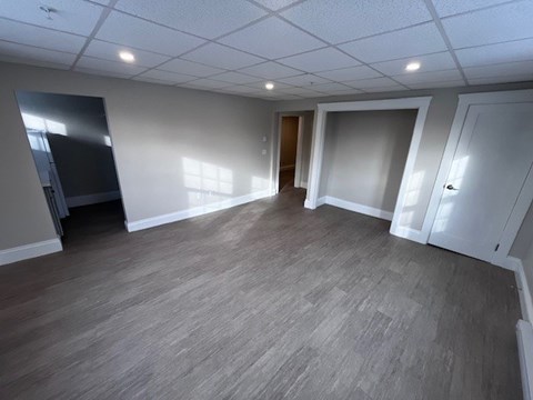 A spacious room with a grey floor and white walls.