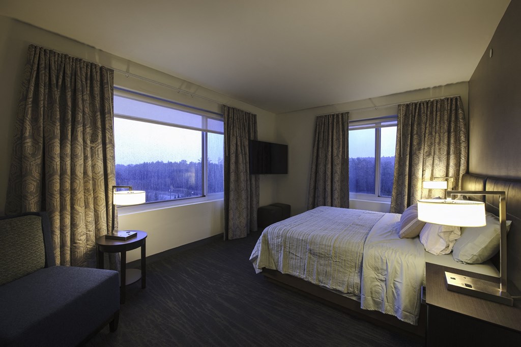a hotel room with a bed and a window