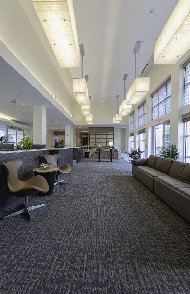 lobby area chairs seating brown leather chair console table access patio