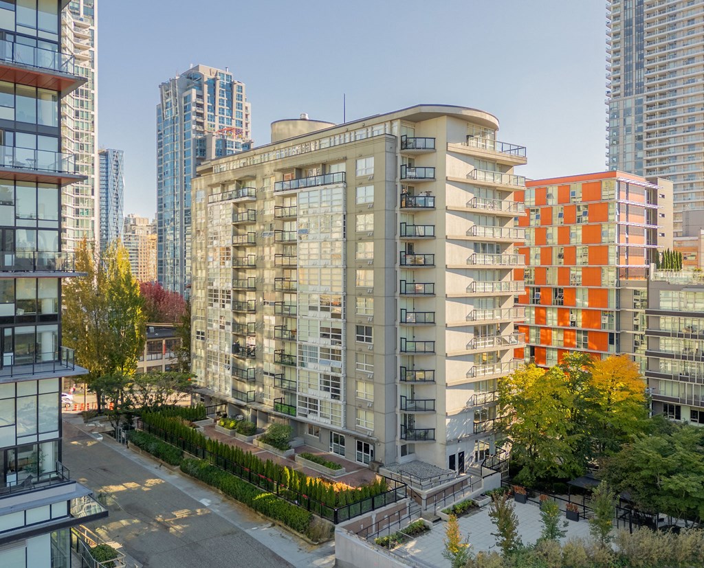 an aerial view of a city with tall buildings and trees