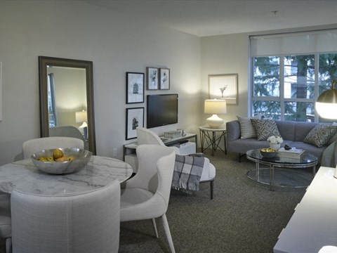 A modern living room with a white chair and a marble table.