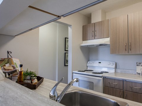 A kitchen with a stove top oven and a sink.