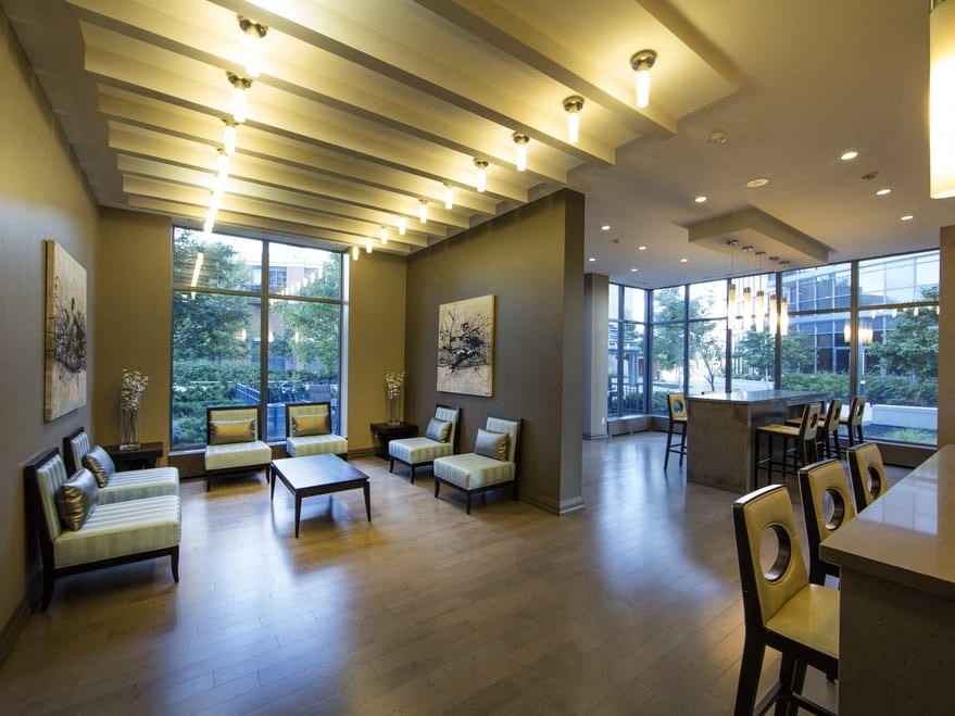 a room with couches chairs and a table in front of a large window