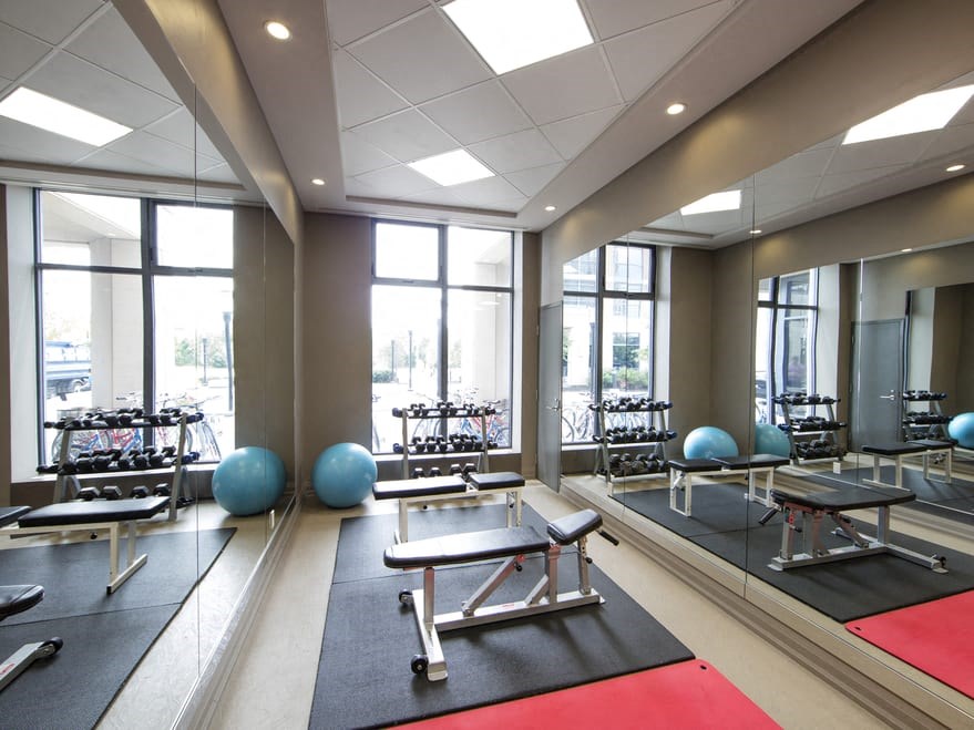 a fitness center with yoga mats and exercise equipment