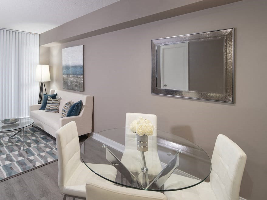 a living room filled with furniture and a large mirror