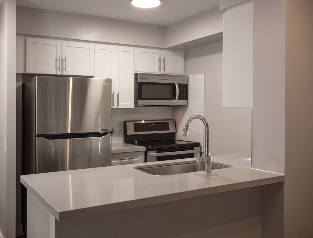 a kitchen with a sink and a refrigerator