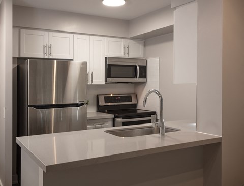 a kitchen with a sink and a refrigerator