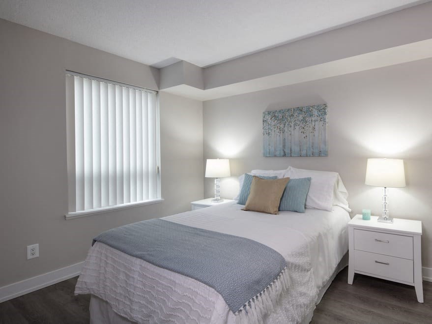 a bedroom with a bed and two night stands