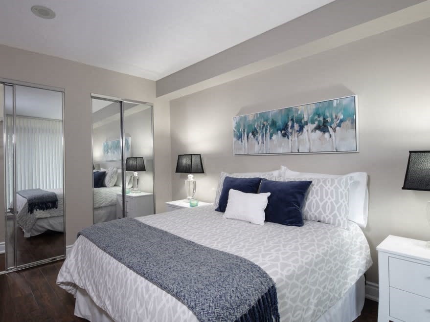 a bedroom with a bed and a mirror