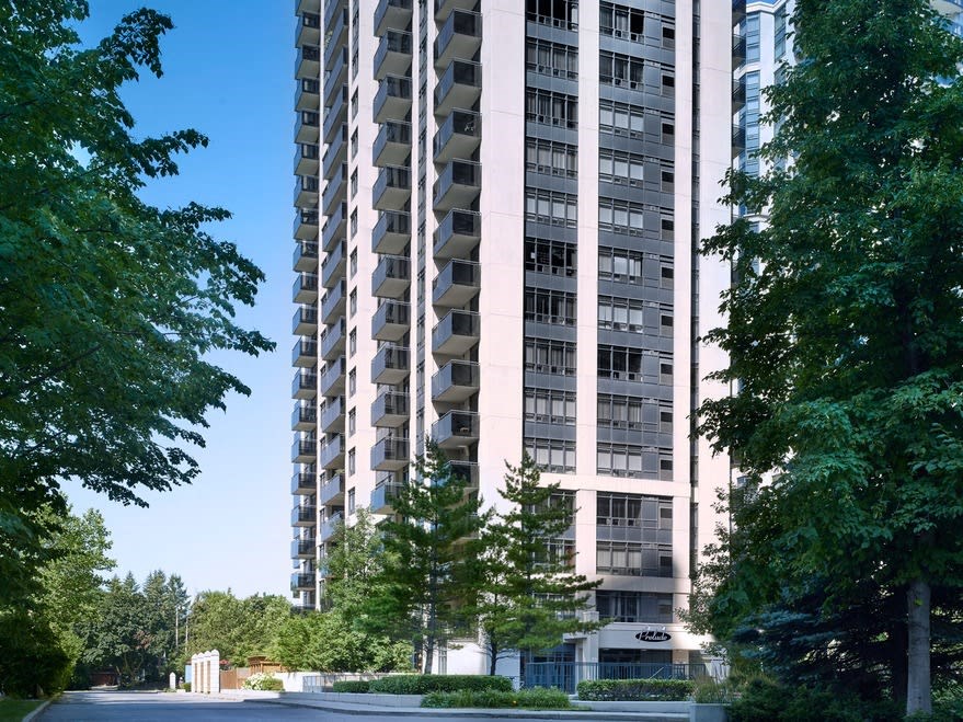 an apartment building with a parking lot in front of it