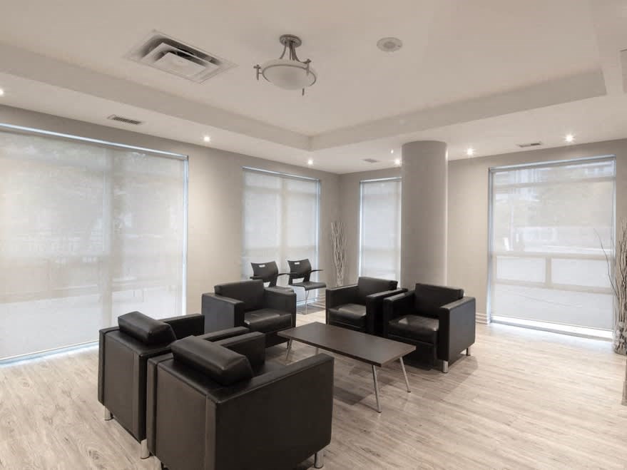 a room filled with black chairs and a table