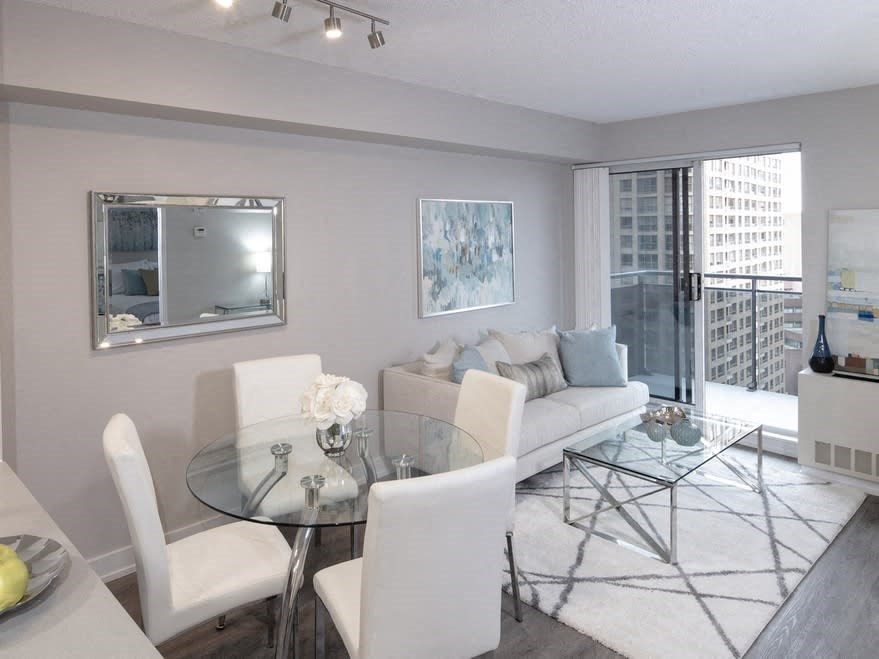 a living room with a glass table and a couch