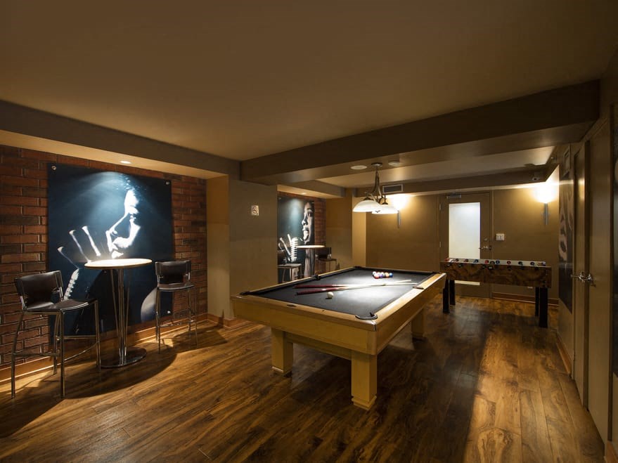 a game room with a pool table and a foosball table