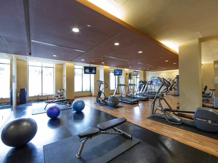 a spacious fitness center with treadmills and other exercise equipment