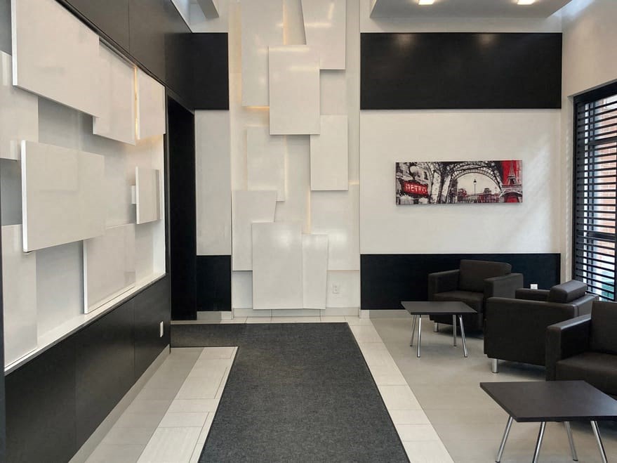 a living room with black and white walls and a white wall with a picture on it