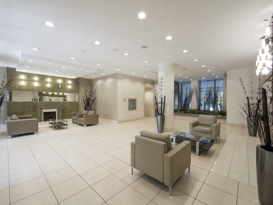 a lobby with couches and chairs and a fireplace