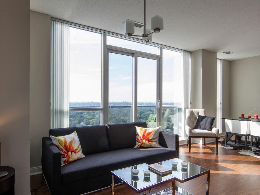 a living room filled with furniture and a large window