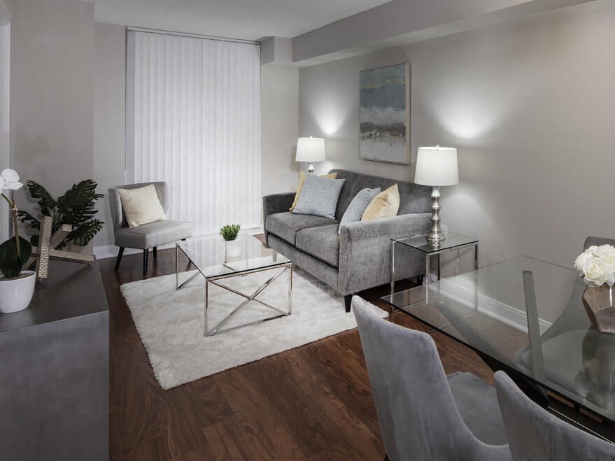 a living room filled with furniture and a large window