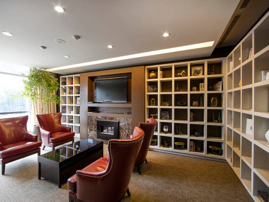 a living room filled with furniture and a large book shelf