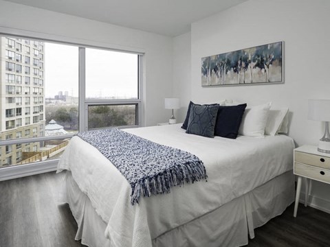 a bedroom with a large bed and a large window