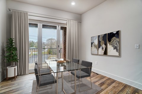 a dining room with a glass table and chairs