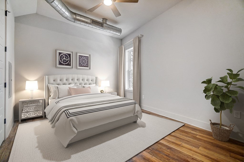 a white bedroom with a white bed and a white rug