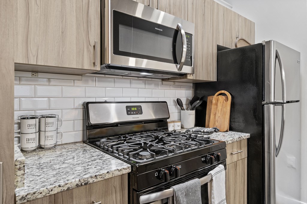 a kitchen with a stove top oven next to a refrigerator