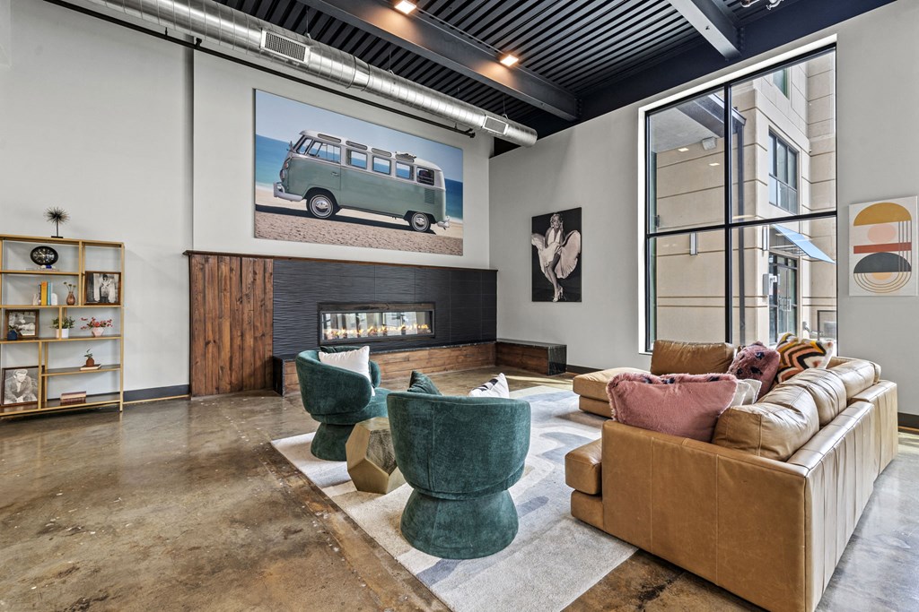 a living room with a fireplace and a large picture of a van on the wall at The Icon, Richmond, VA 23230