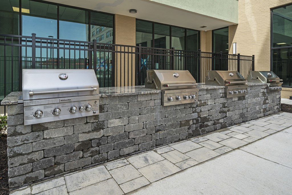 a retaining wall with three grills in front of a building at The Icon, Richmond, VA 23230