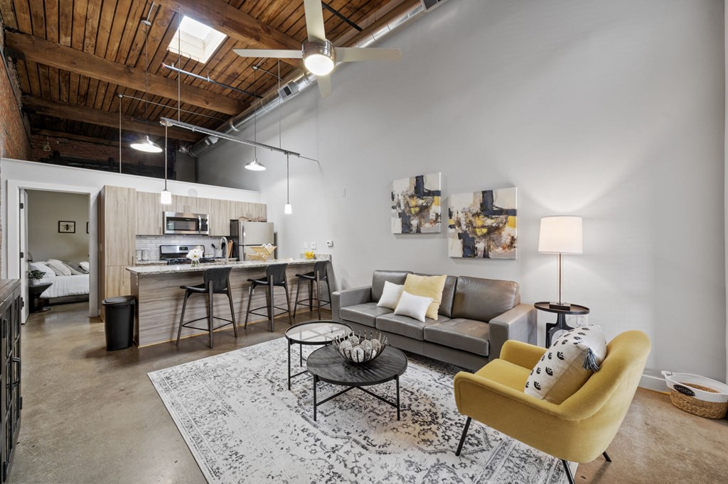 a living room with white walls and a wooden ceiling