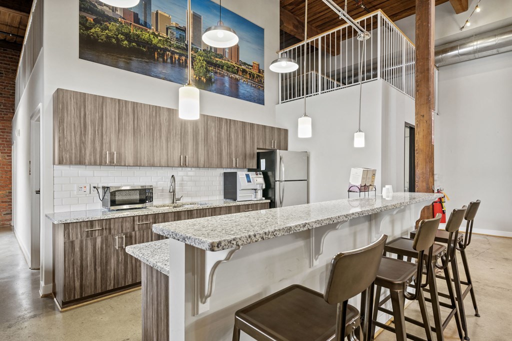 a kitchen with a long counter and stools