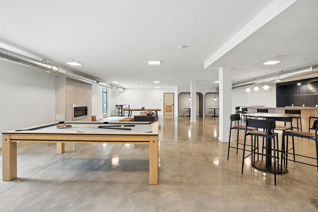 A room with a long table and chairs.
