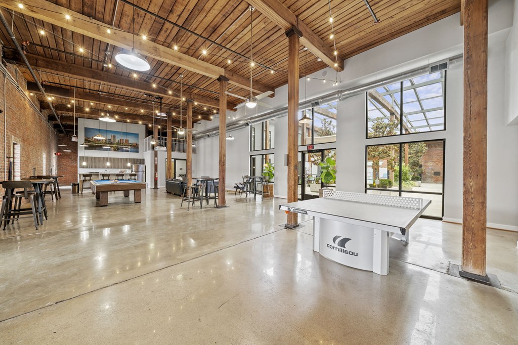 a ping pong table sits in the middle of a large room