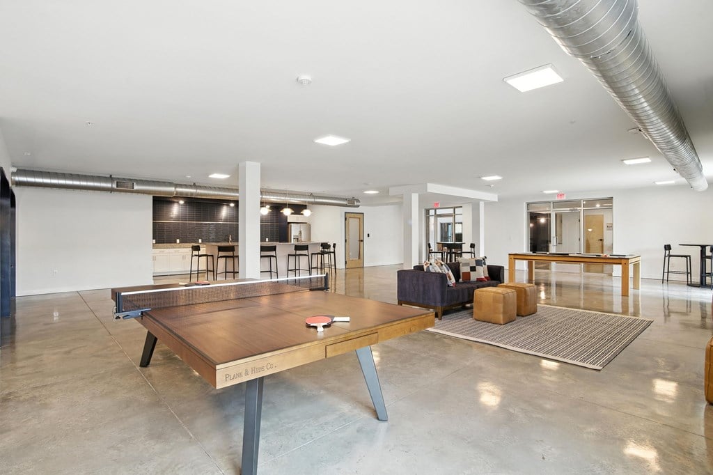 A large room with a long wooden table in the center.