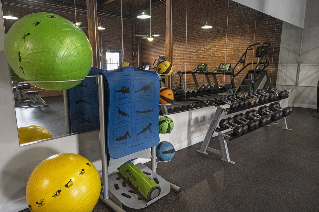 a fitness room with weights and other exercise equipment