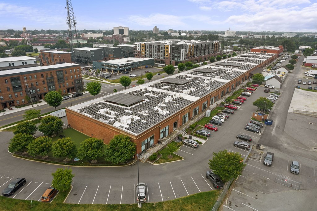a large brick building with a lot of solar panels on top of it