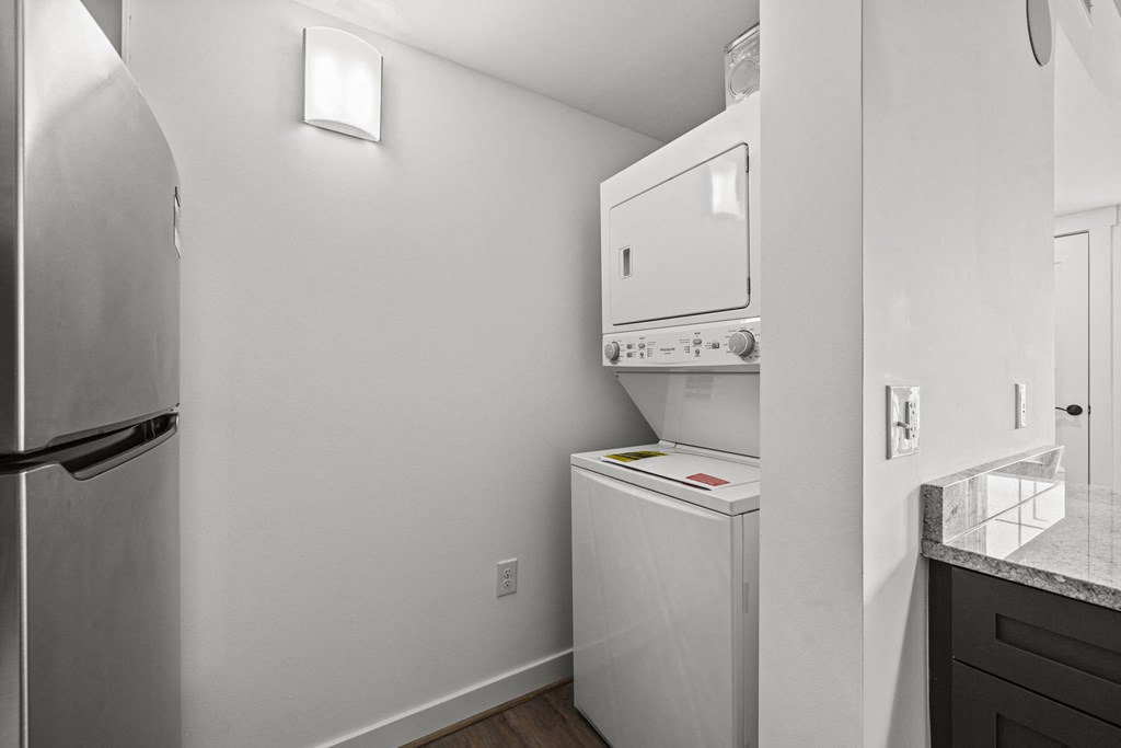 a small laundry room with a washer and dryer  at The Icon, Richmond, VA 23230