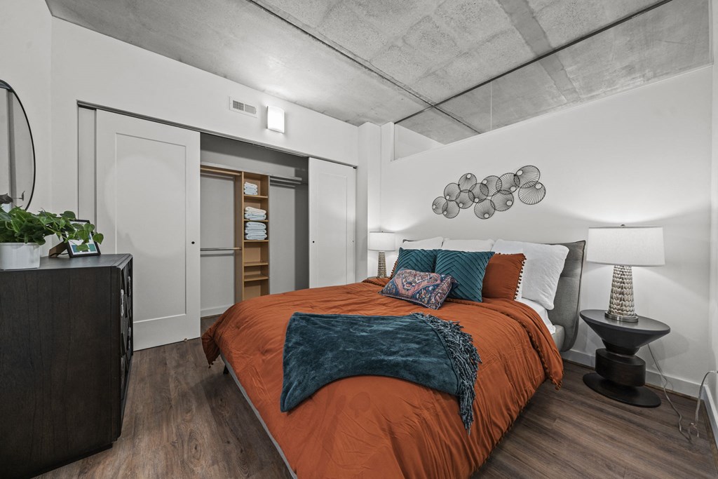 a bedroom with a bed and a nightstand  at The Icon, Richmond, VA 23230