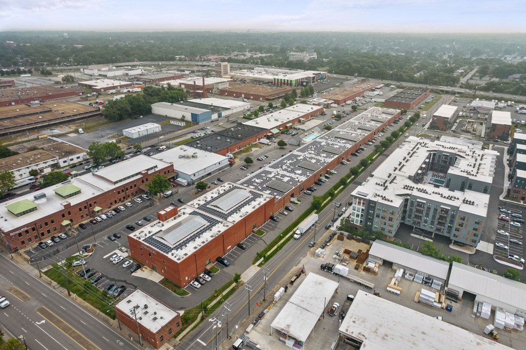 a view from the top of a building of a city street and parking lot