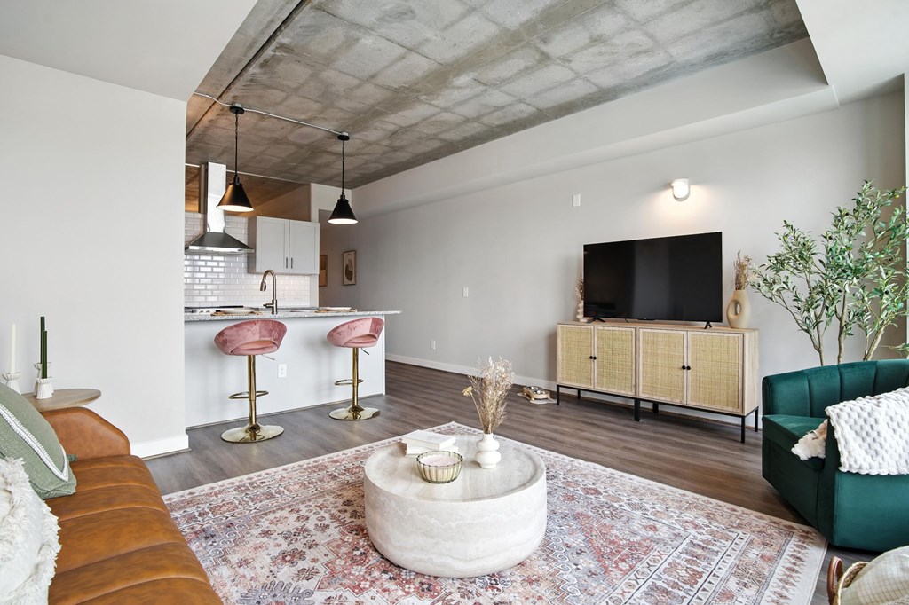 A living room with a brown leather couch and a white coffee table.