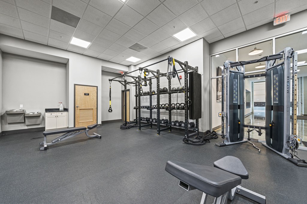 a fully equipped fitness room with free weights and other equipment  at The Icon, Richmond, VA 23230