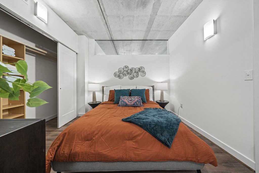 a bedroom with a bed and a closet at The Icon, Richmond, VA 23230